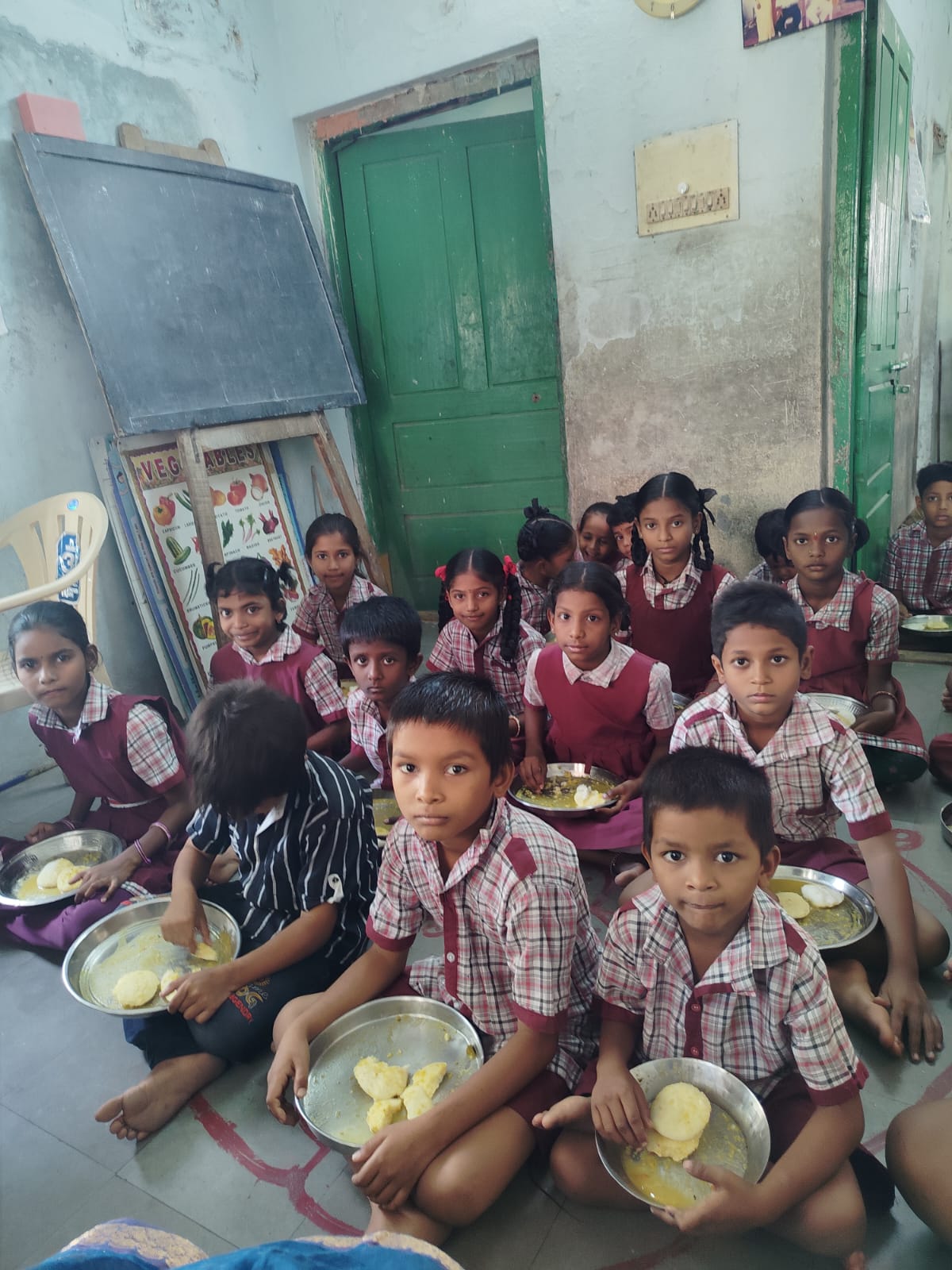 Schoolchildren in uniform eating a free breakfast served by the trust