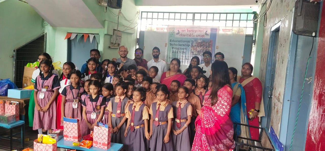 Schoolchildren in uniform with scholarship book and stationery bags under the trust banner