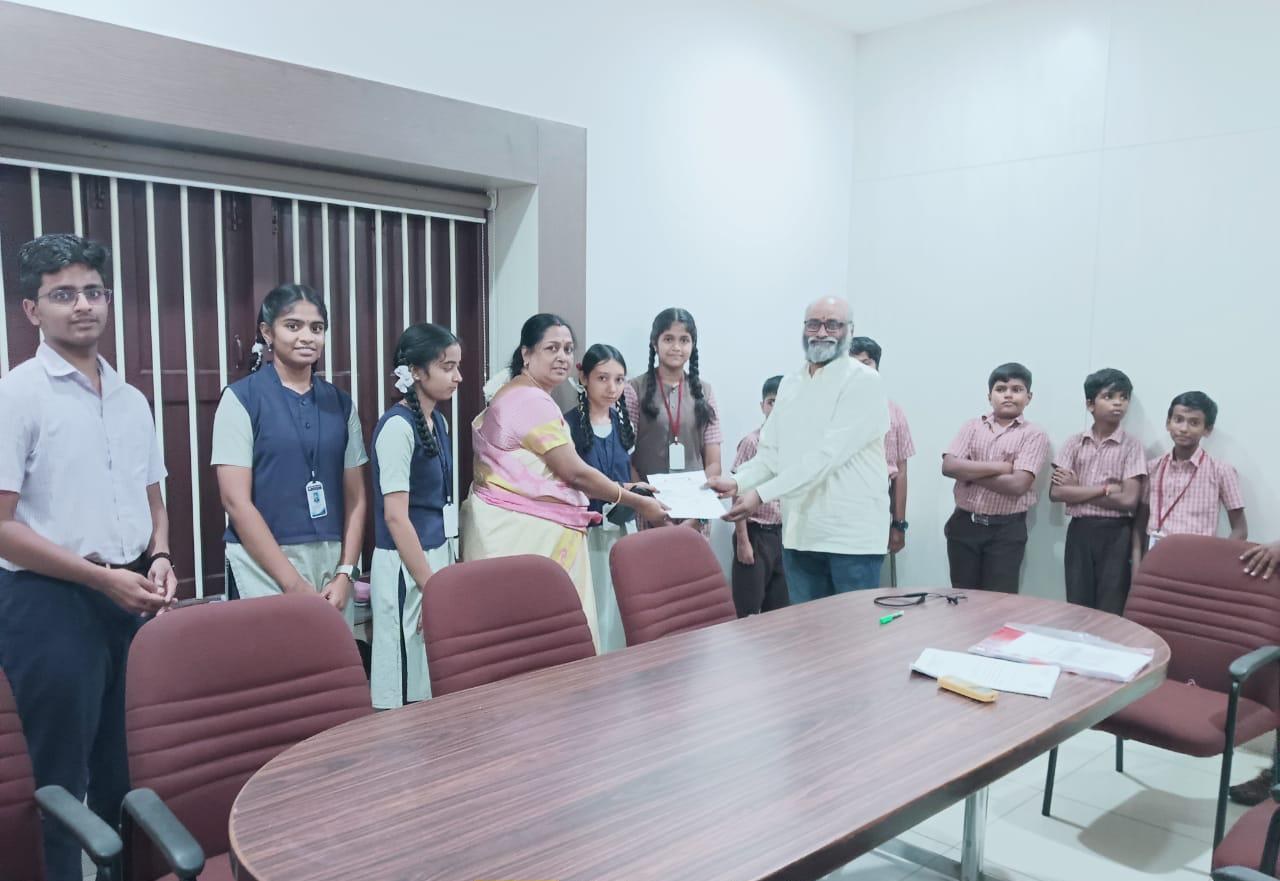 The trust's founder presenting an education scholarship to schoolchildren, funded through CSR